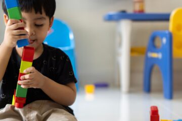 Young child playing with blocks.