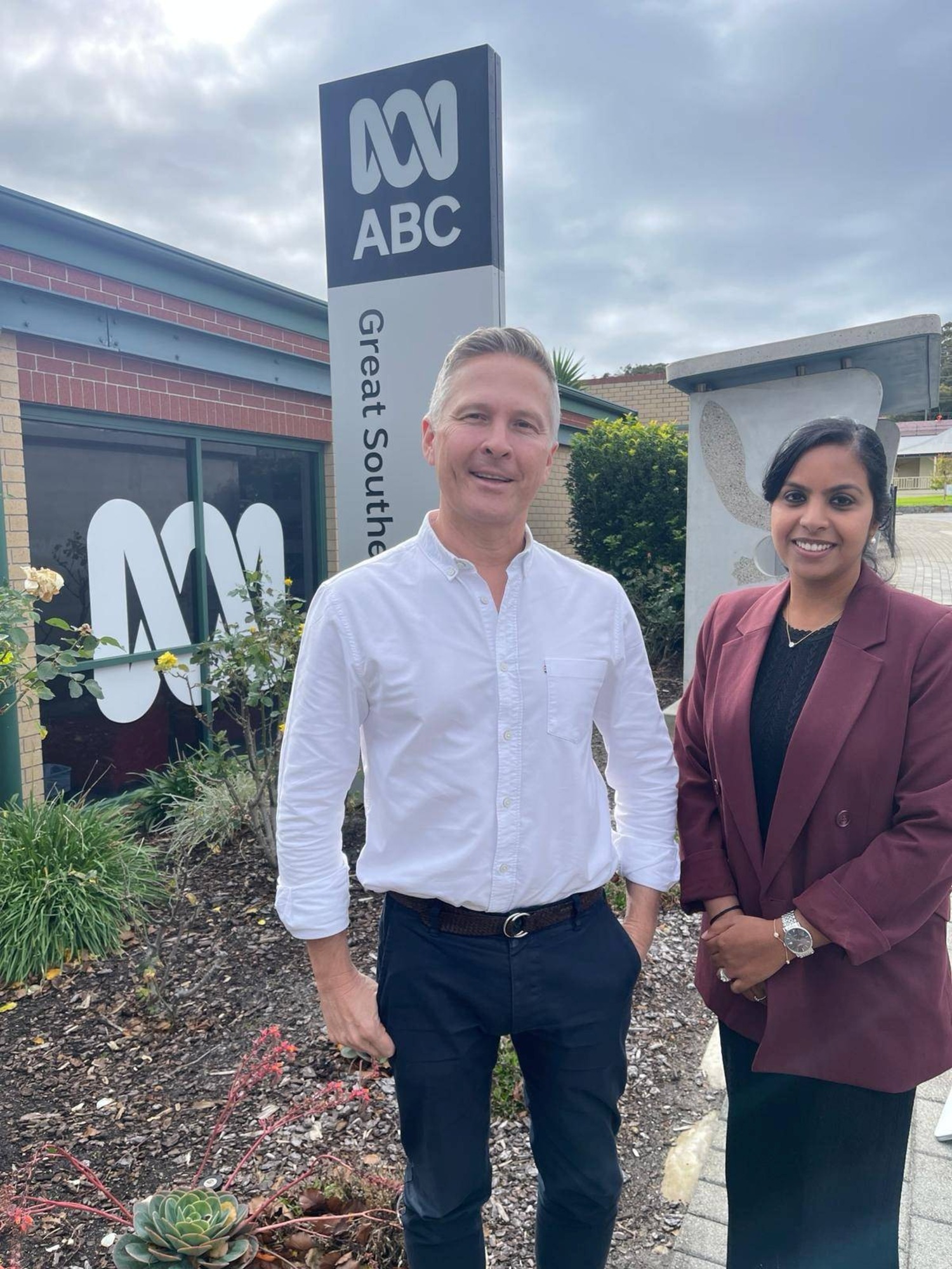 A man and a woman standing in front of the ABC Great Sothern building.